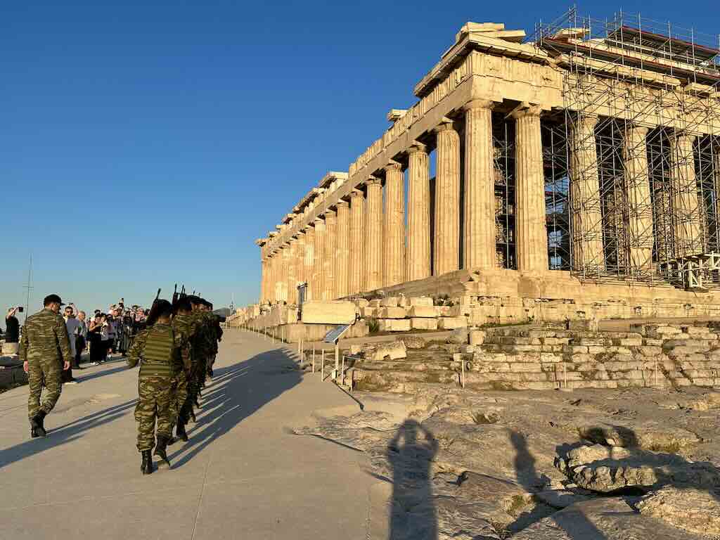 Greek guards crossing the Acropolis near the Parthenon at sunset before the flag ceremony
