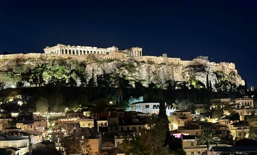 Acropolis of Athens at night with illuminated Parthenon above the city