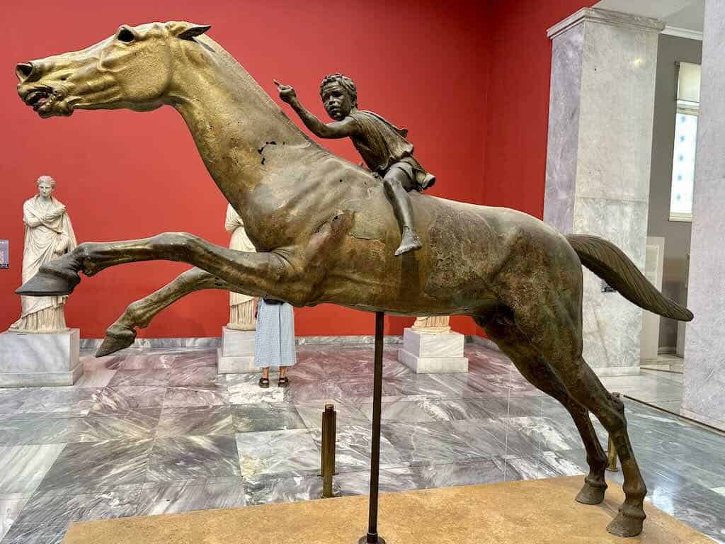 Statue of a young jockey riding a horse at the National Archaeological Museum in Athens