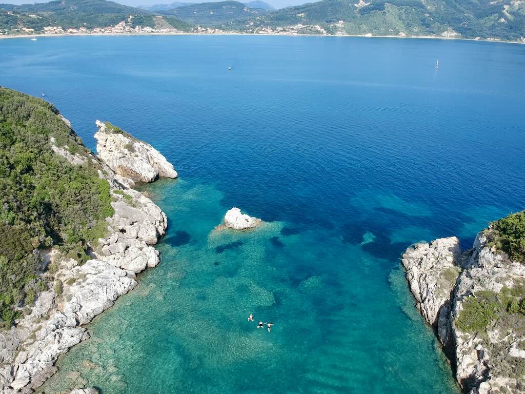 Crystal-clear waters of Porto Timoni bay with Agios Georgios in the background, Corfu