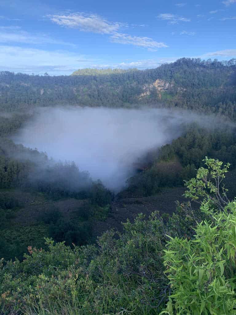 Mist pouring into a crater of Kelimutu