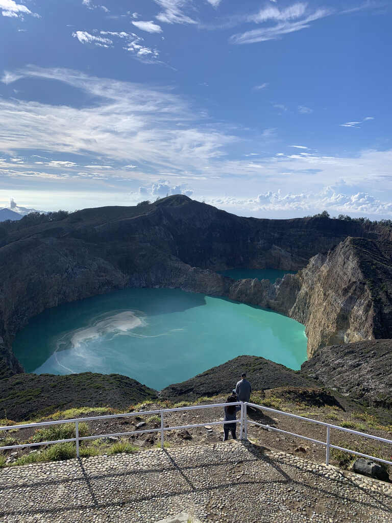 The railed rim path above a crater lake on the way to Kelimutu's viewpoint