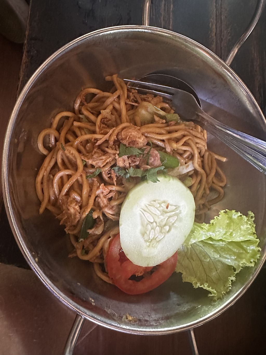 A bowl of bakmi Jawa Javanese noodles with egg, tomato and lettuce in Yogyakarta, Java, Indonesia