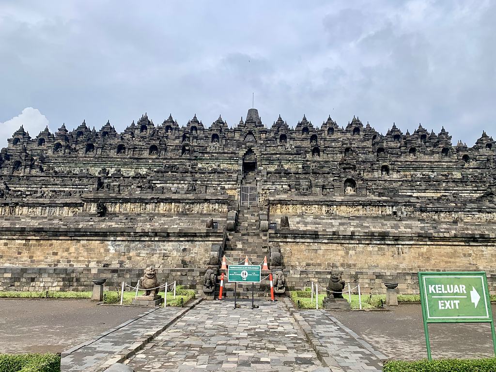 Borobudur with the staircase to the upper terraces closed off by barriers and exit signs during Covid, January 2021, Java, Indonesia