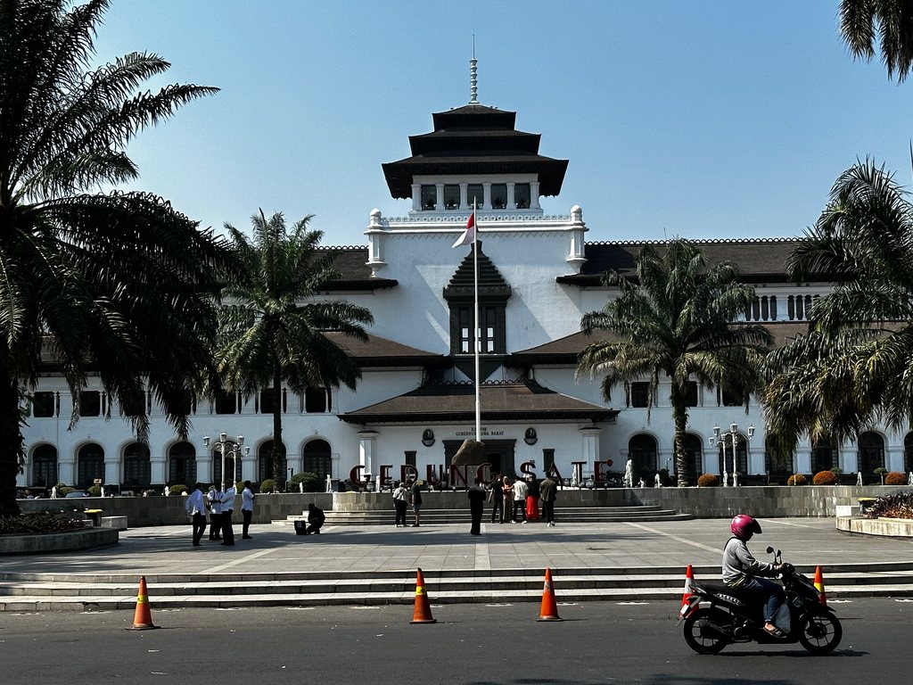 Gedung Sate in Bandung seen from across the avenue with palm trees, Java, Indonesia