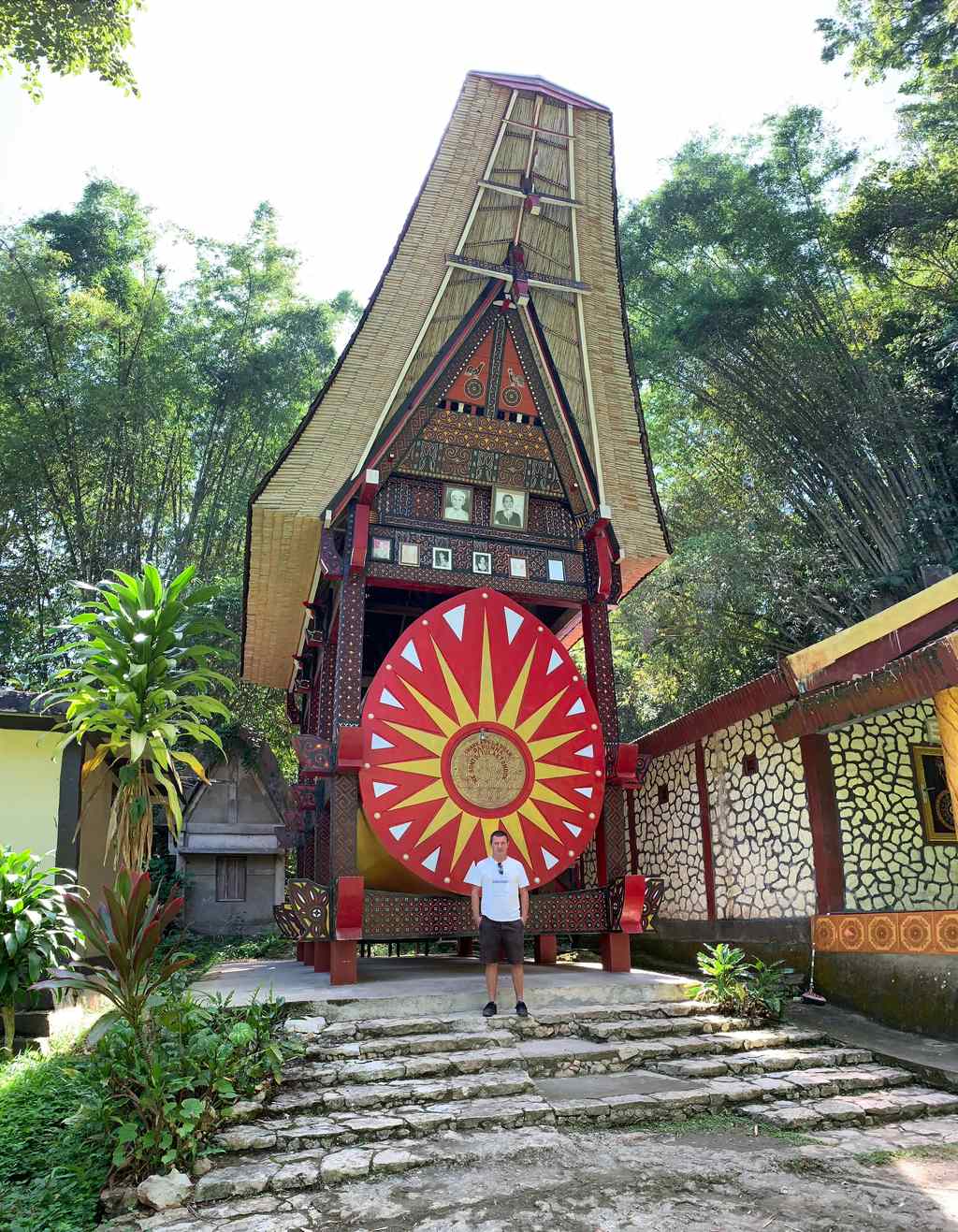 Portale intagliato con disco solare rosso e ritratti di famiglia incorniciati a Ke'te Kesu, Tana Toraja