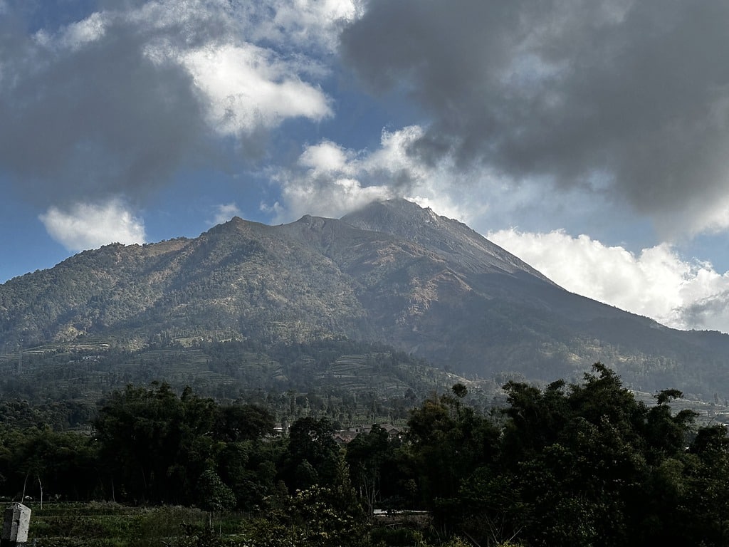 Mount Merapi seen from the road north of Yogyakarta with cloud over the summit, Java, Indonesia