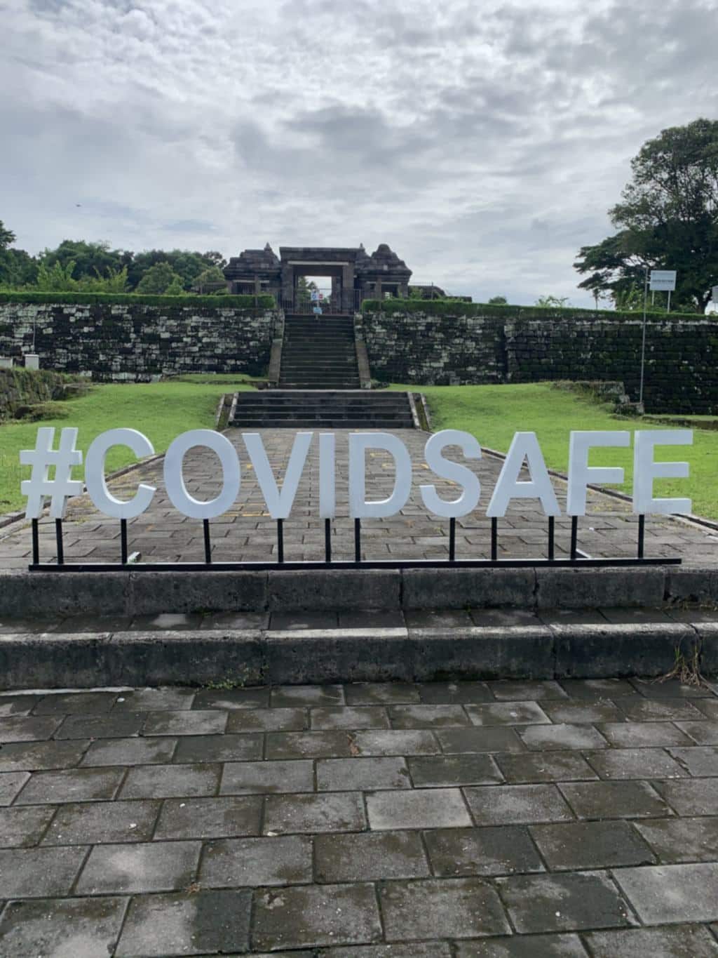 A large concrete hashtag COVIDSAFE sign at the entrance to Prambanan temple in January 2021, Java, Indonesia