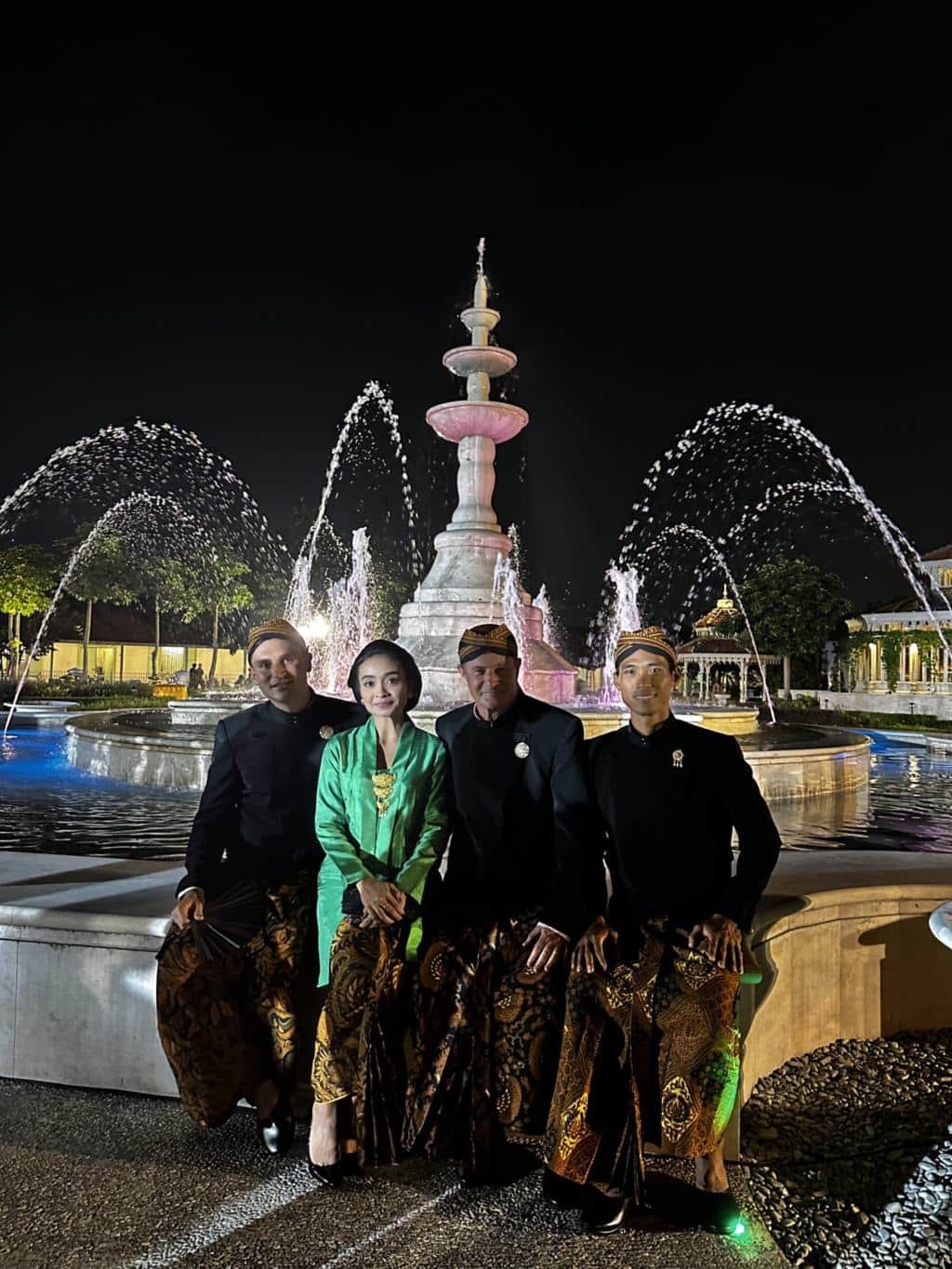 The Surakarta palace lit up at night with fountains and guests in Javanese dress, Solo, Java, Indonesia