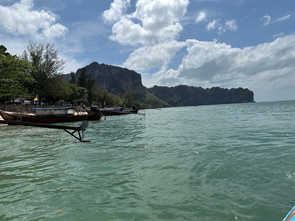 Longtail-Boote am östlichen Ende von Ao Nang Beach unterhalb der Kalksteinfelsen