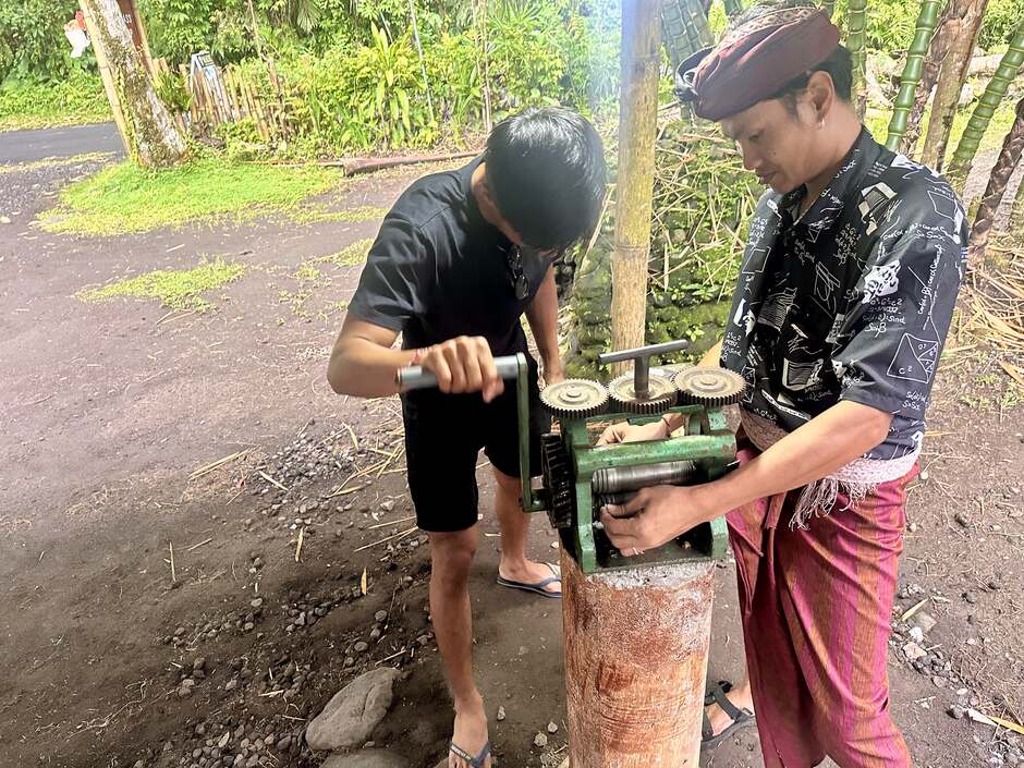 Silversmith working a hand-cranked rolling mill, Sidemen Karangasem Bali