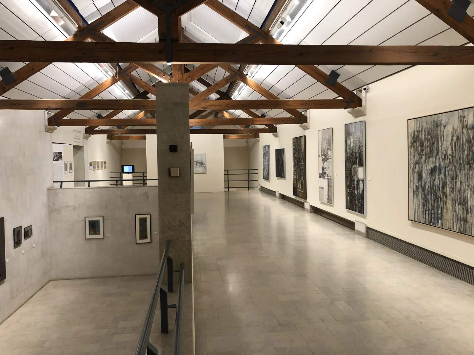 An exhibition hall under the wooden roof beams of the Arpad Szenes–Vieira da Silva Foundation
