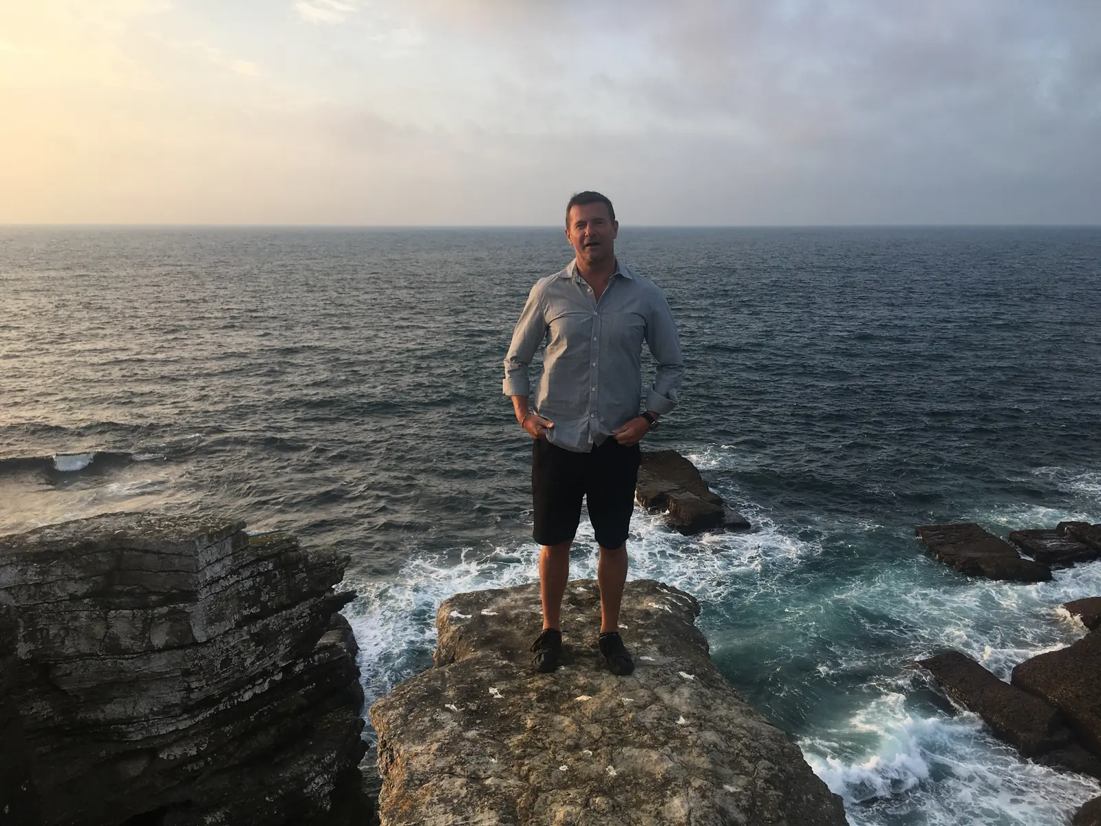 Blaise Jaeger on a rock above the Atlantic at Cabo Carvoeiro, Peniche, at sunset