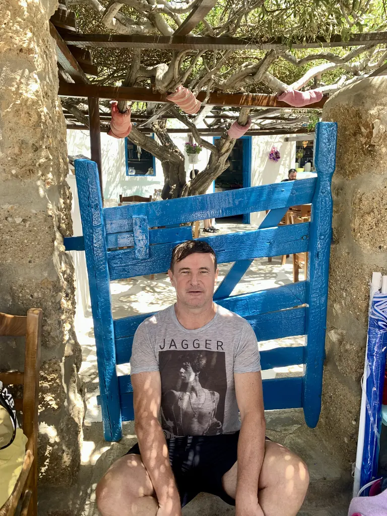 Blaise Jaeger at the blue gate of Kiki's Tavern, Agios Sostis, Mykonos