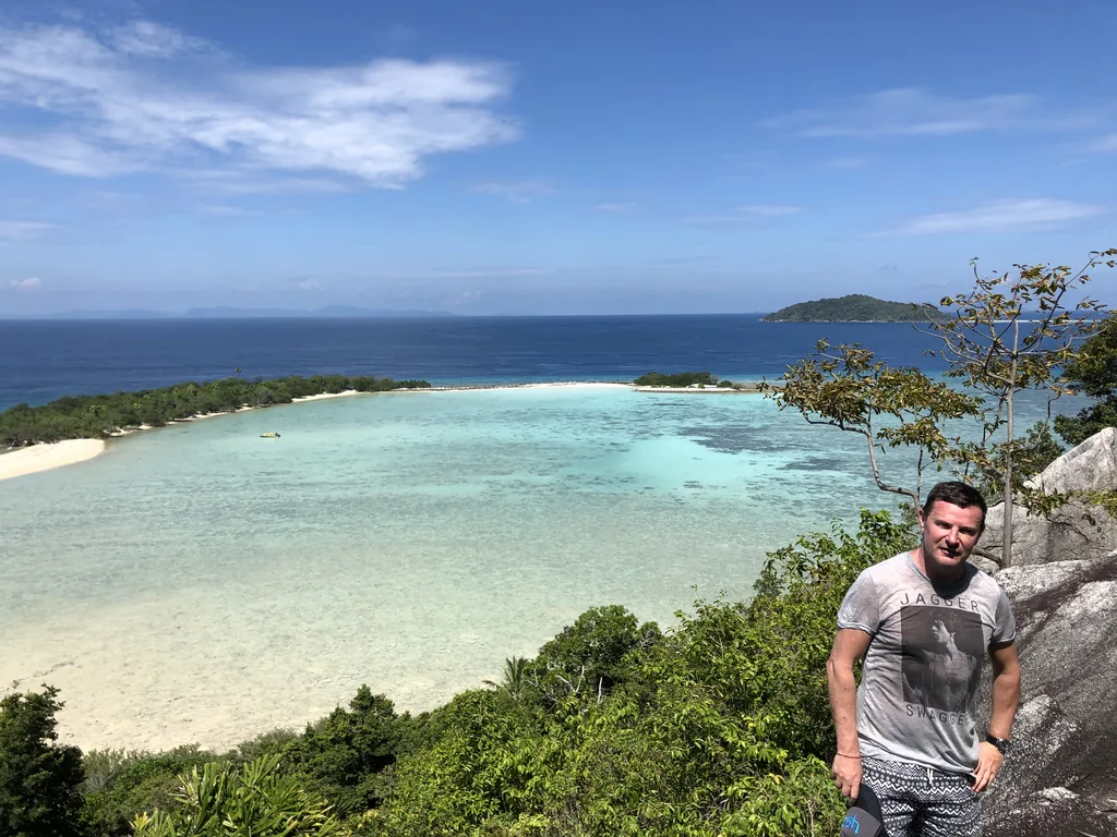 Blaise Jaeger at a viewpoint above a turquoise lagoon in the Anambas Islands