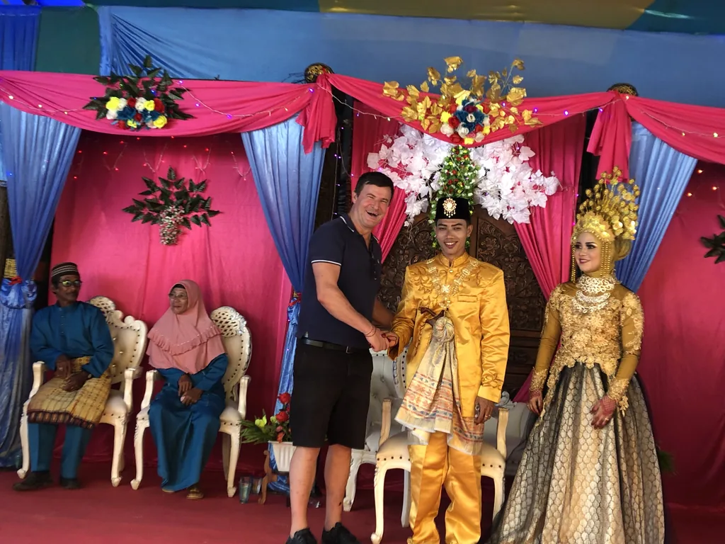 Blaise Jaeger with the bride and groom at a Malay wedding in the Anambas Islands