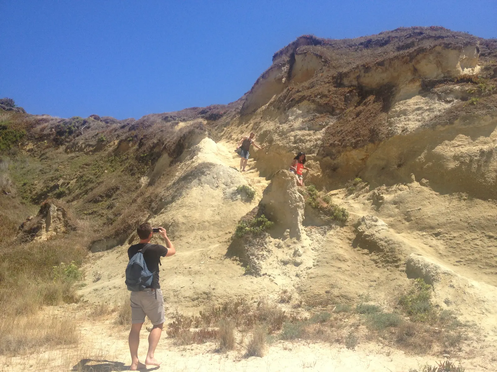 Blaise Jaeger standing among the sandstone cliffs at Meco
