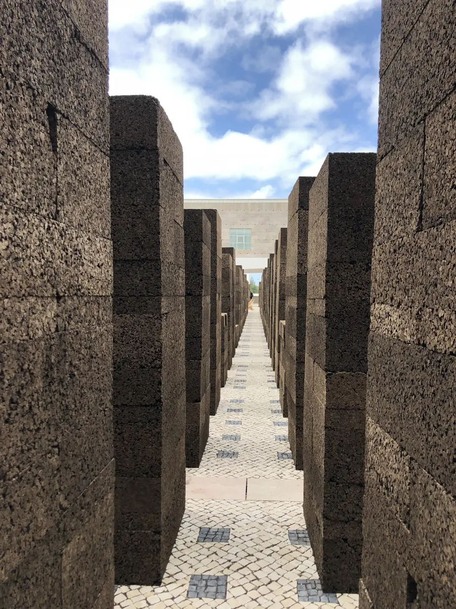 A corridor between tall stone blocks at the Centro Cultural de Belém