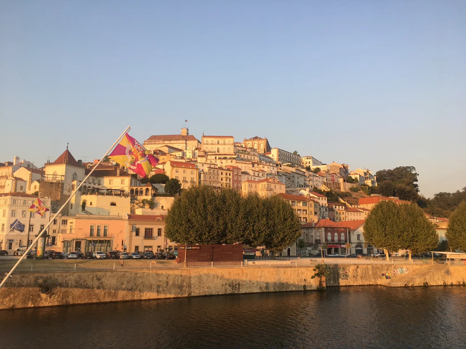 The old town of Coimbra on its hill above the Mondego river at golden hour