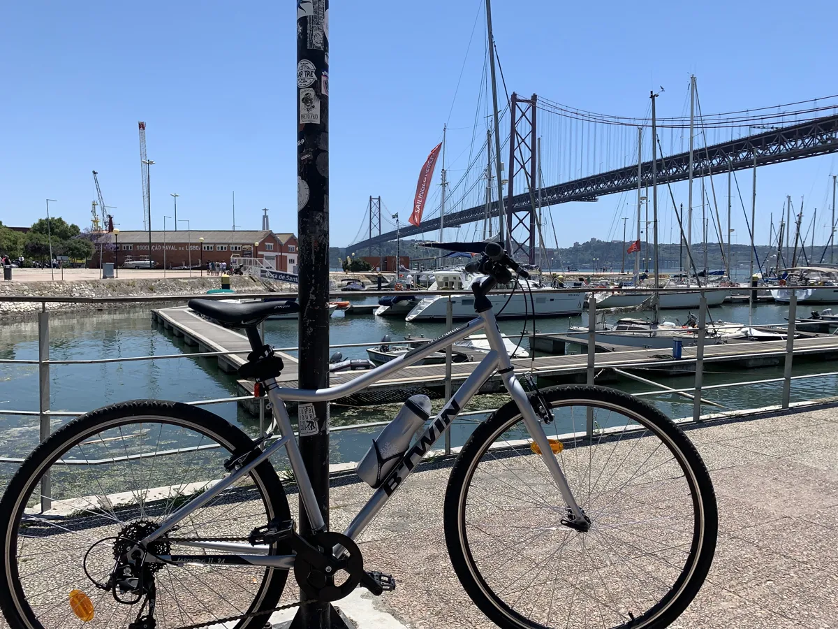 A bicycle on the riverside promenade at the Doca de Santo Amaro under the 25 de Abril bridge