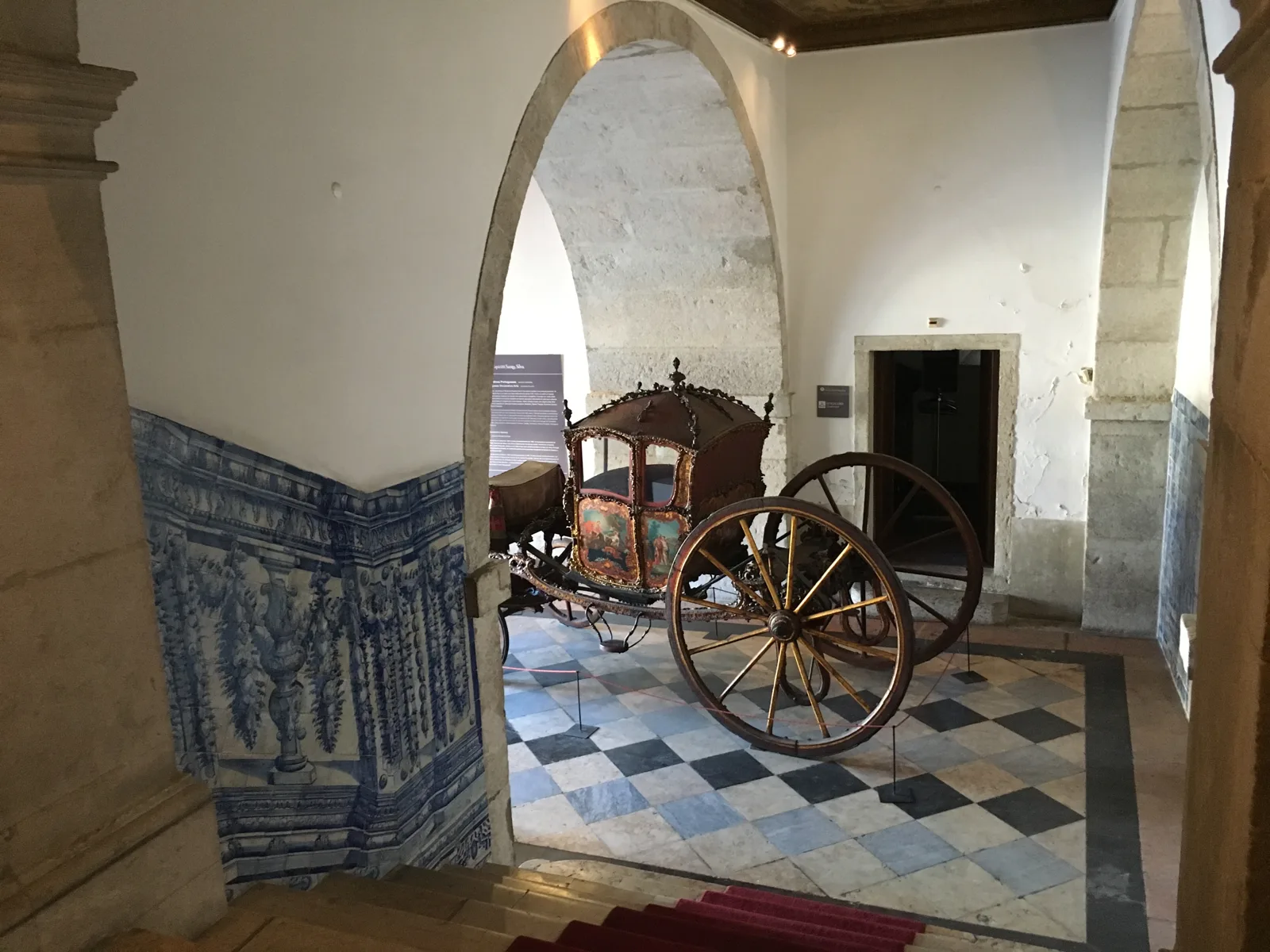 An old carriage in the azulejo-lined entrance of the Ricardo do Espírito Santo Silva Foundation