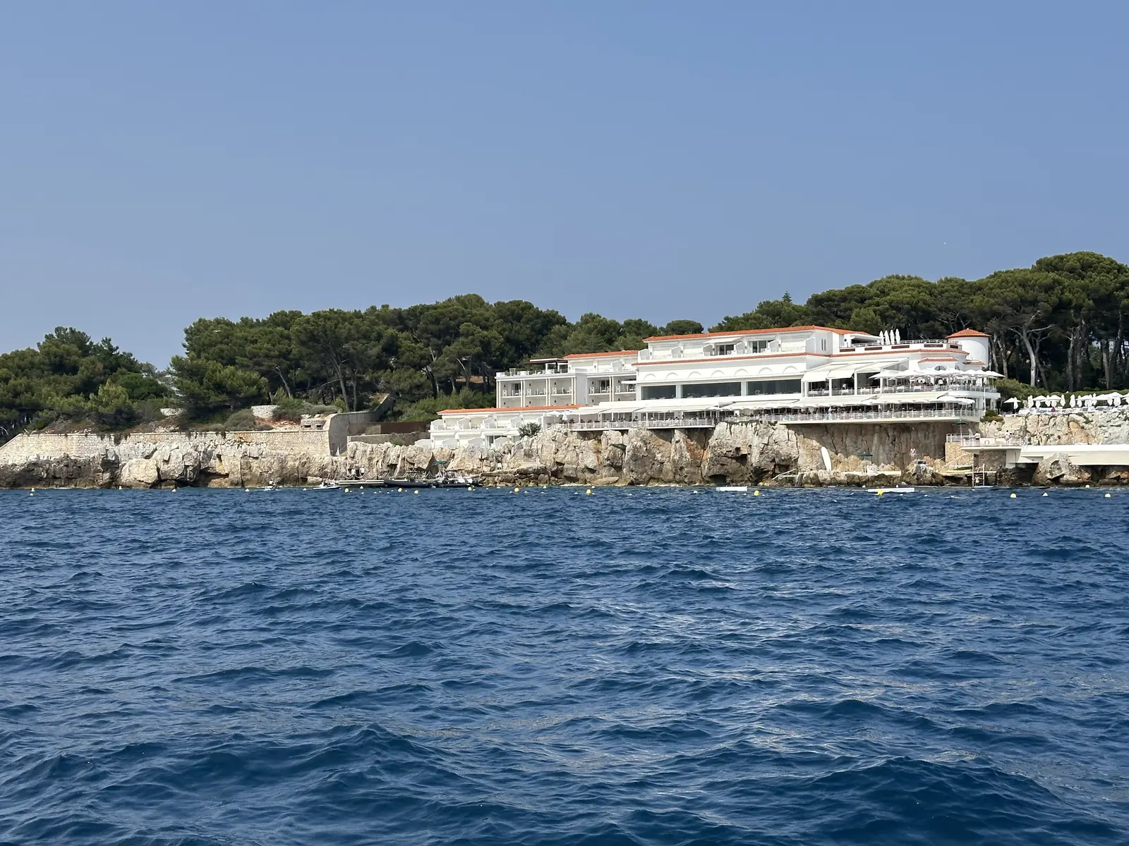 The Eden-Roc restaurant of the Hôtel du Cap-Eden-Roc on the rocks of Cap d’Antibes, seen from a boat