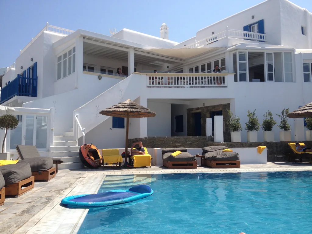 The pool and white buildings of the Rochari Hotel in Mykonos Town