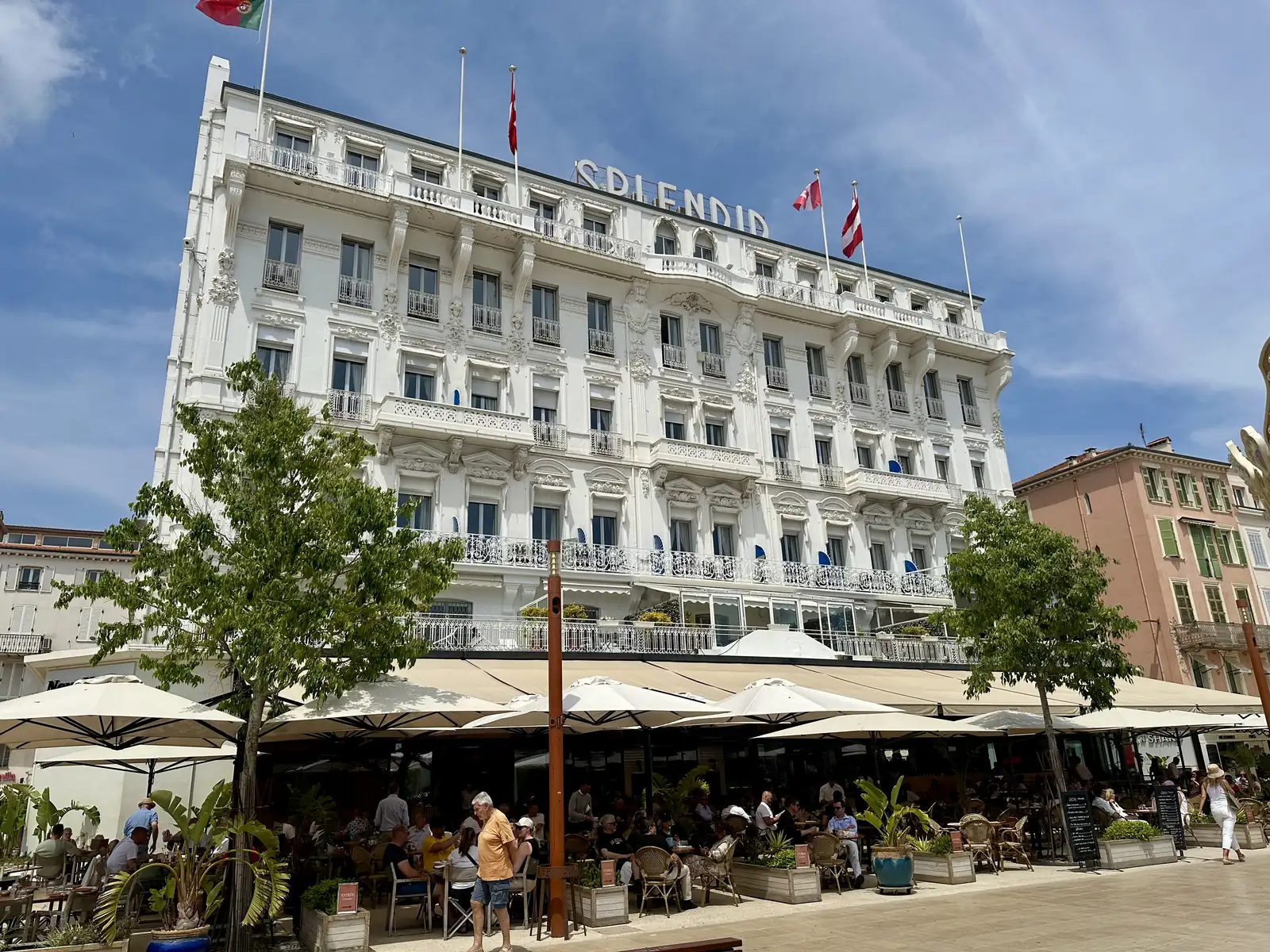 The white facade of the Hôtel Splendid in Cannes with its terrace