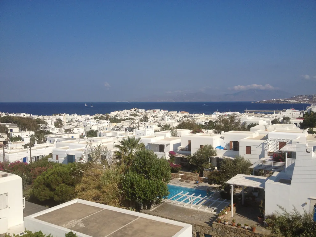 Whitewashed houses of Mykonos Town and the sea seen from the hillside