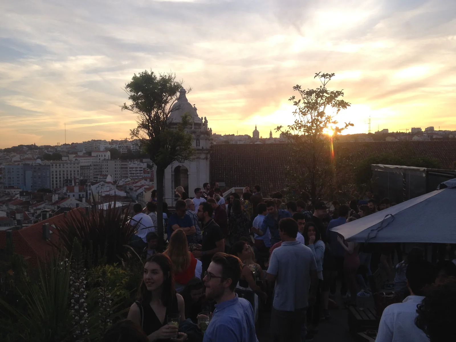 The crowd on the rooftop terrace of the Park bar at sunset in Lisbon