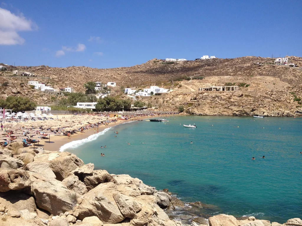 The bay of Super Paradise beach with turquoise water and rocks, Mykonos