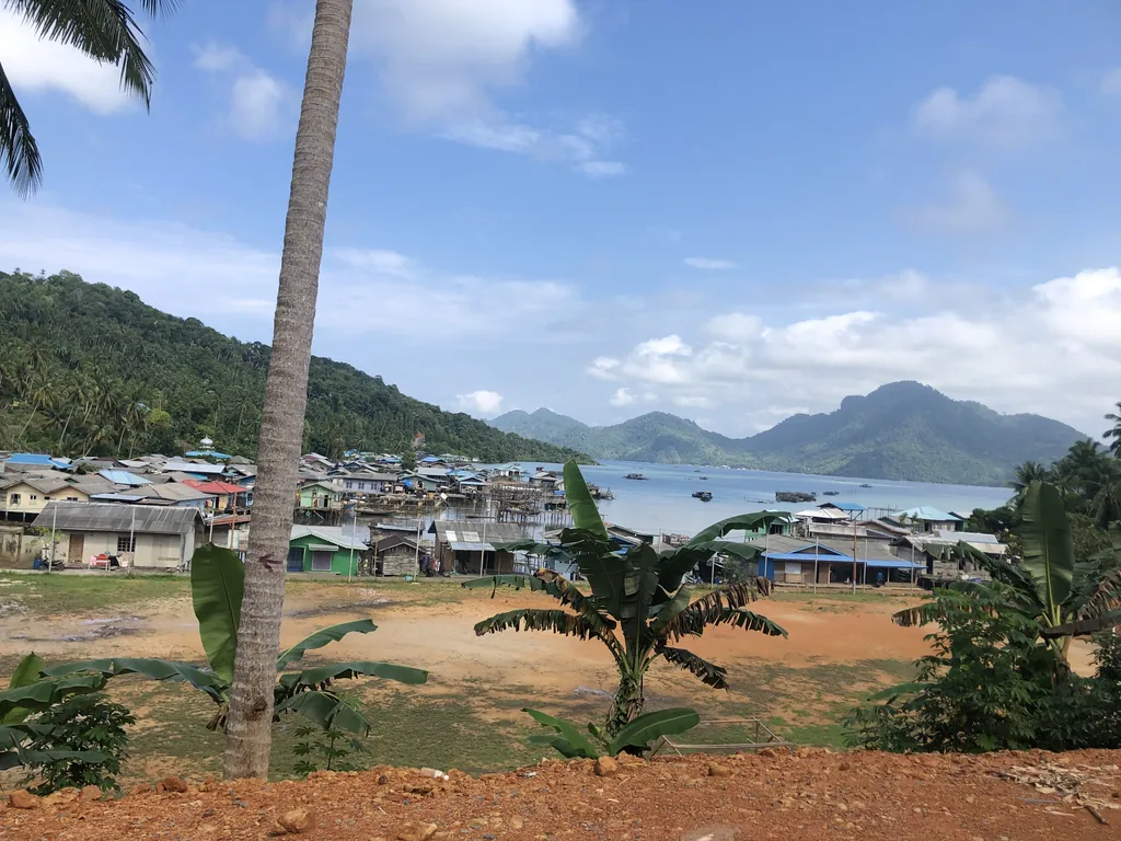 Stilt houses of Tarempa on Siantan island, Anambas, with the mountains behind