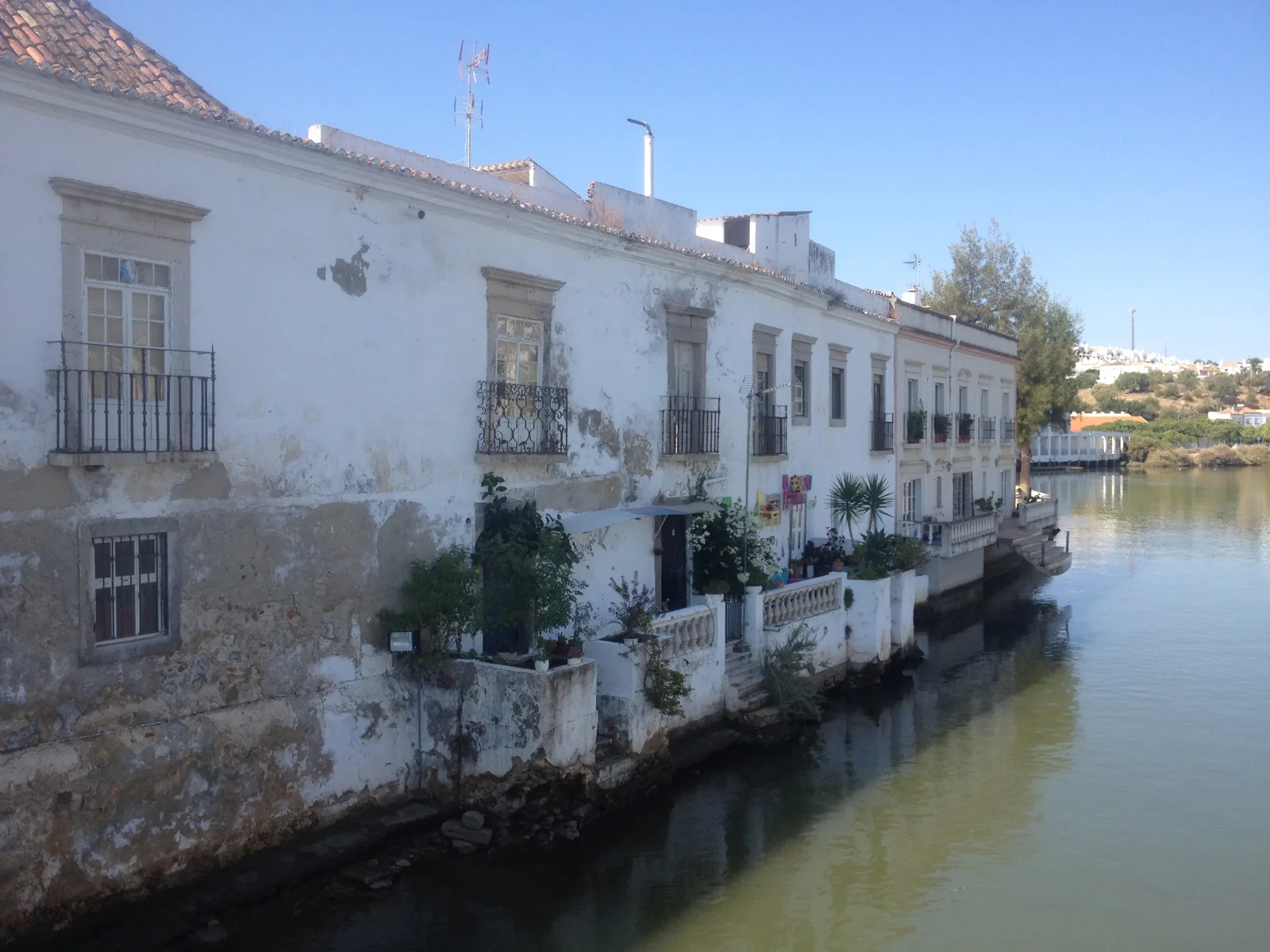 White houses with balconies along the Gilão river in Tavira