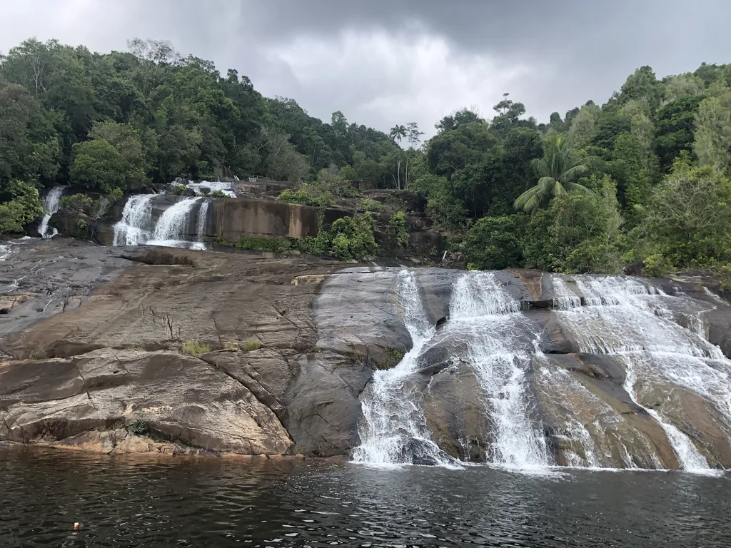 The Temburun waterfall flowing over granite slabs on Siantan, Anambas Islands
