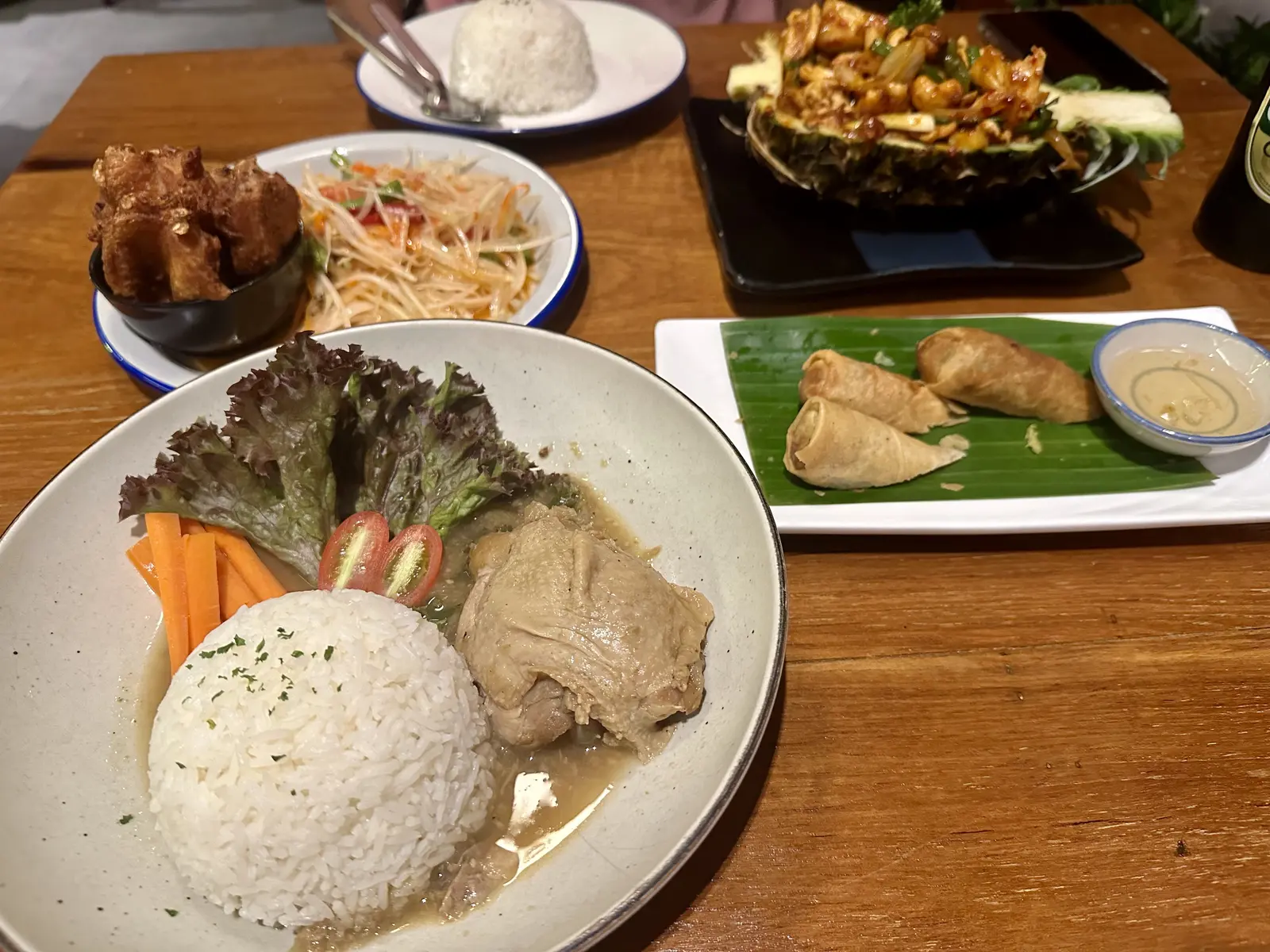Thai dishes with rice, salad and spring rolls in a restaurant in Thonglor, Bangkok