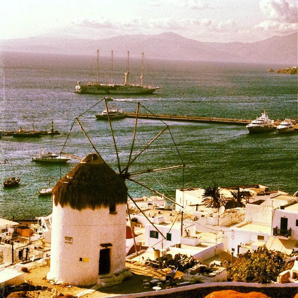 Boni windmill above the old port of Mykonos with yachts in the bay